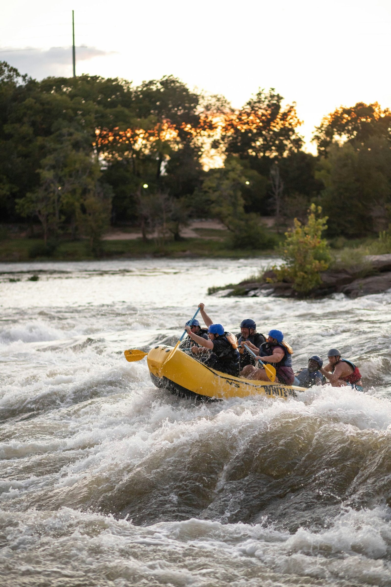 a group of people riding a raft down a river